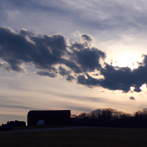 Suggested Prompt: A silhouette of a farm with a cloudy sky and a sun setting in the background.